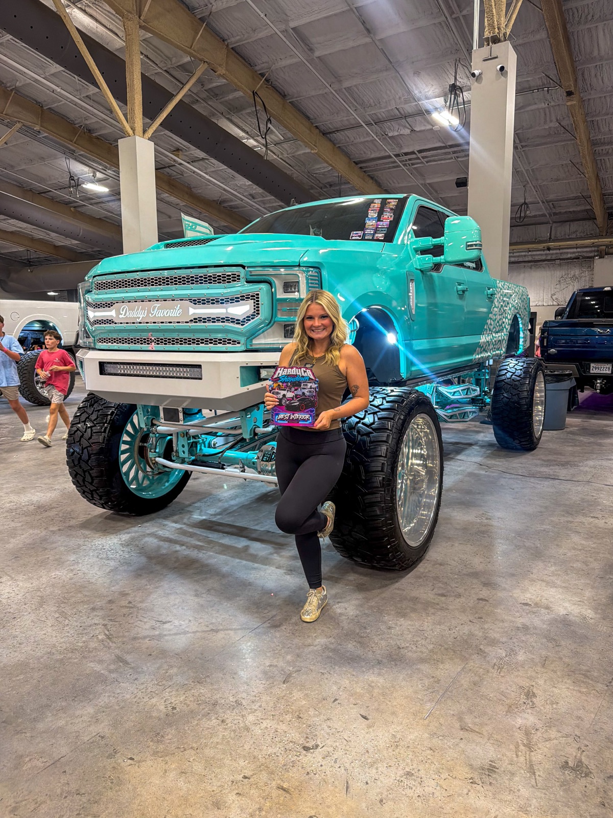 A clean lifted show truck staged under the lights at the HardyCo Showdown
