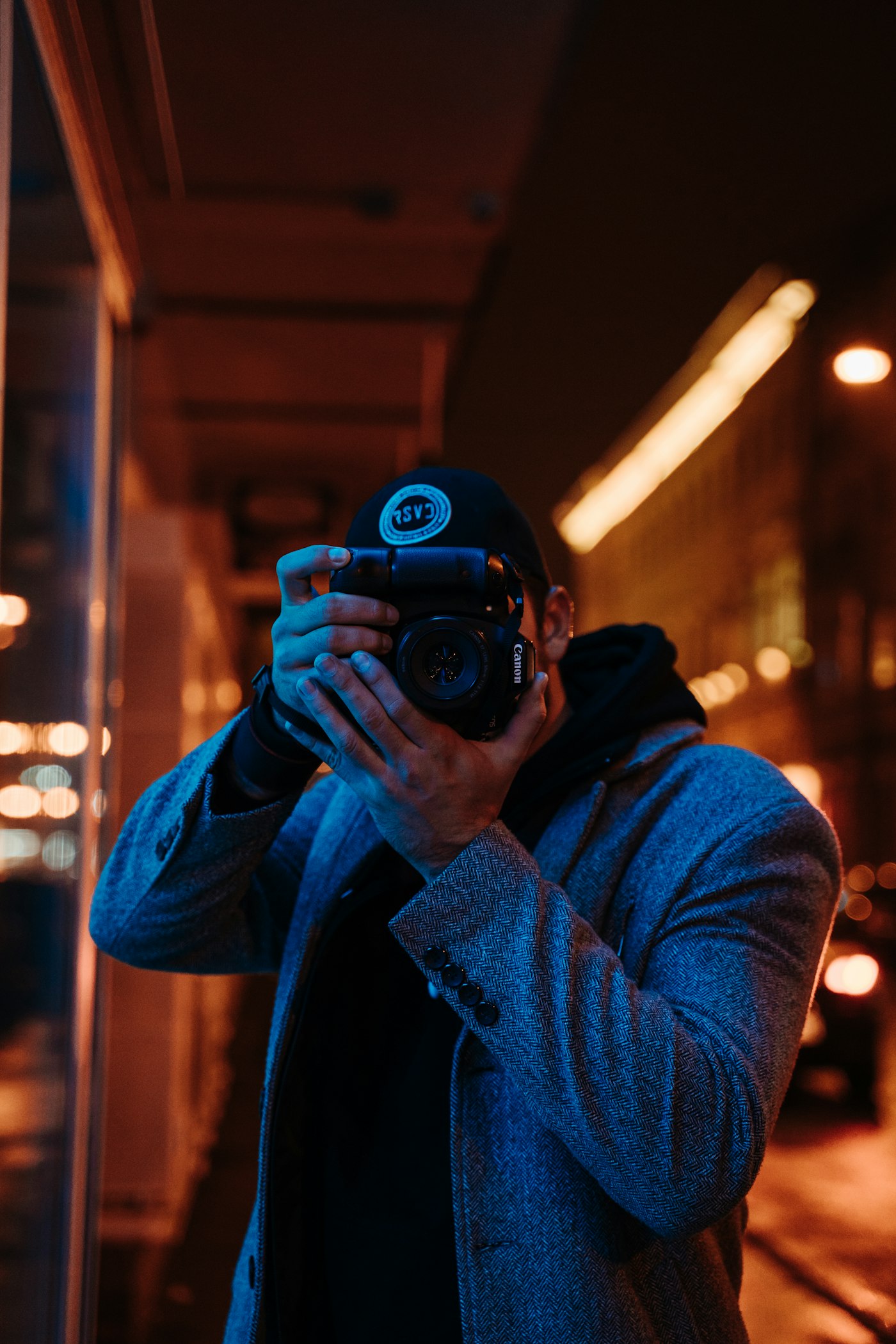A photographer shooting with a DSLR camera at night